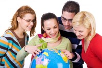 Group of students holding a world globe